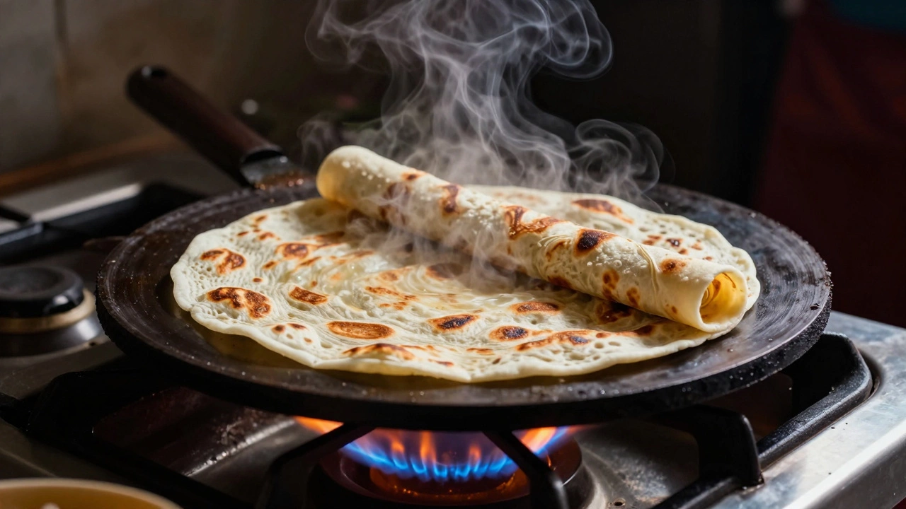 Roti puffing up with steam on a hot griddle over an open gas flame